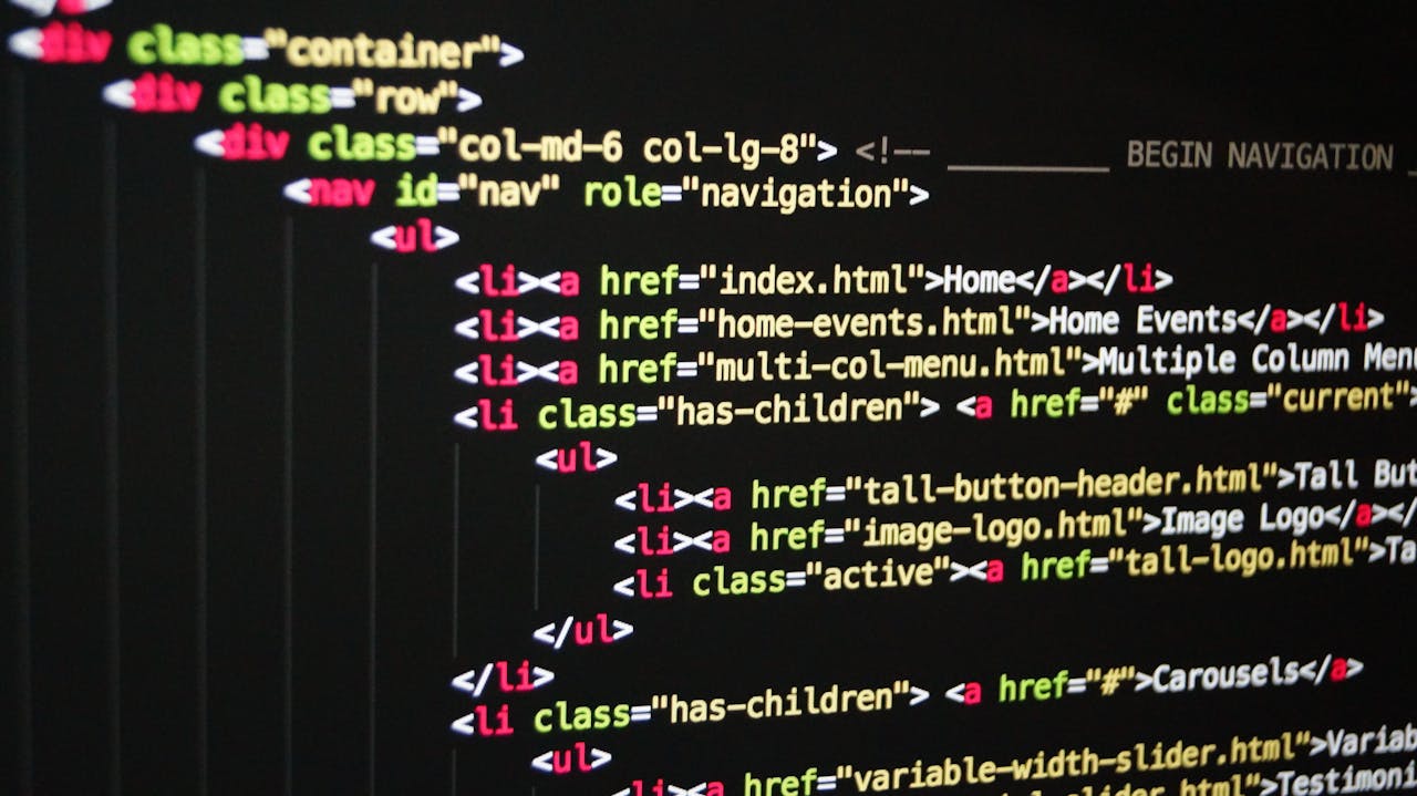 about-01 Close-up of vibrant HTML code displayed on a computer screen, showcasing web development and programming.